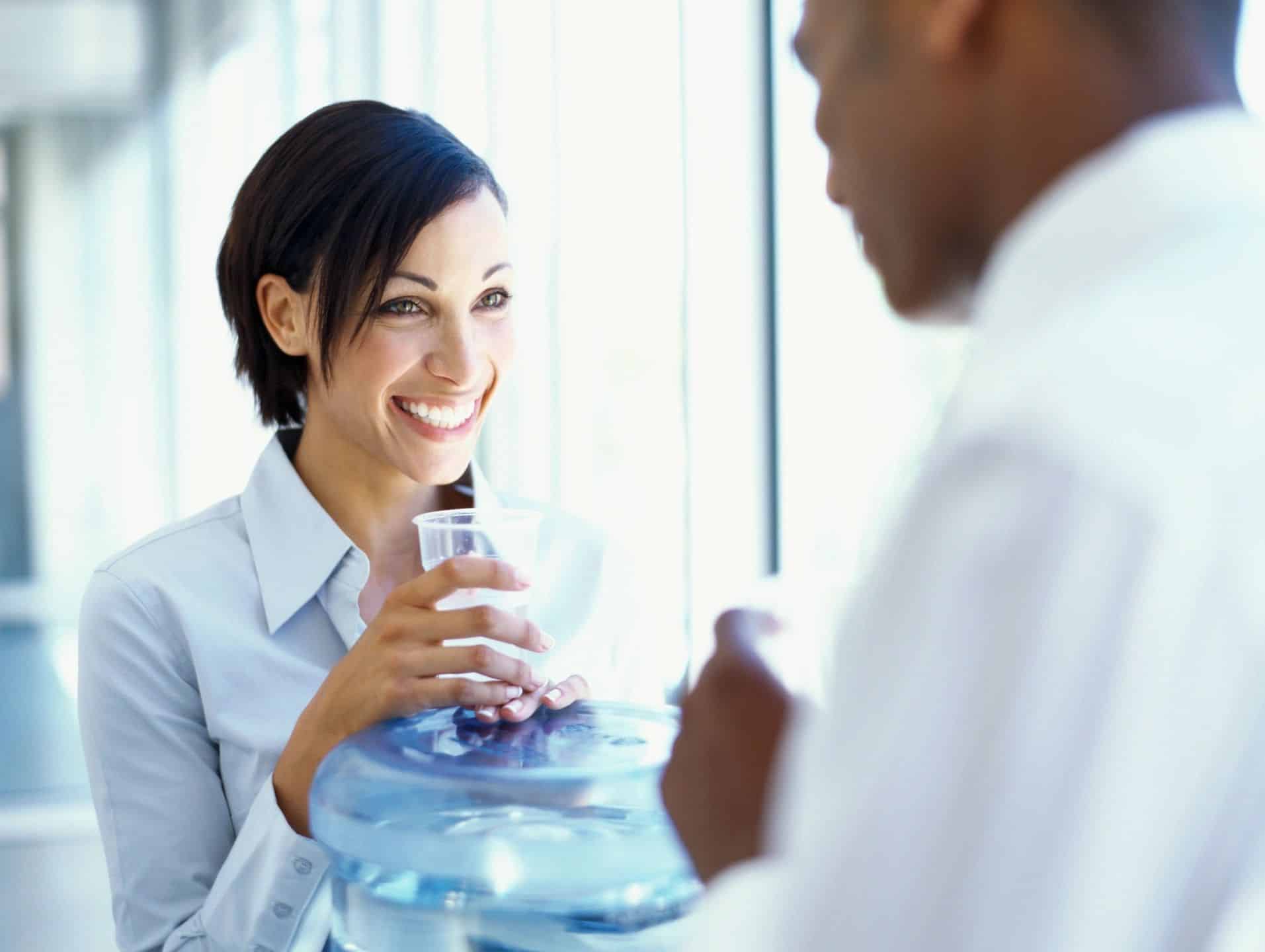 Woman smiling with a glass of water