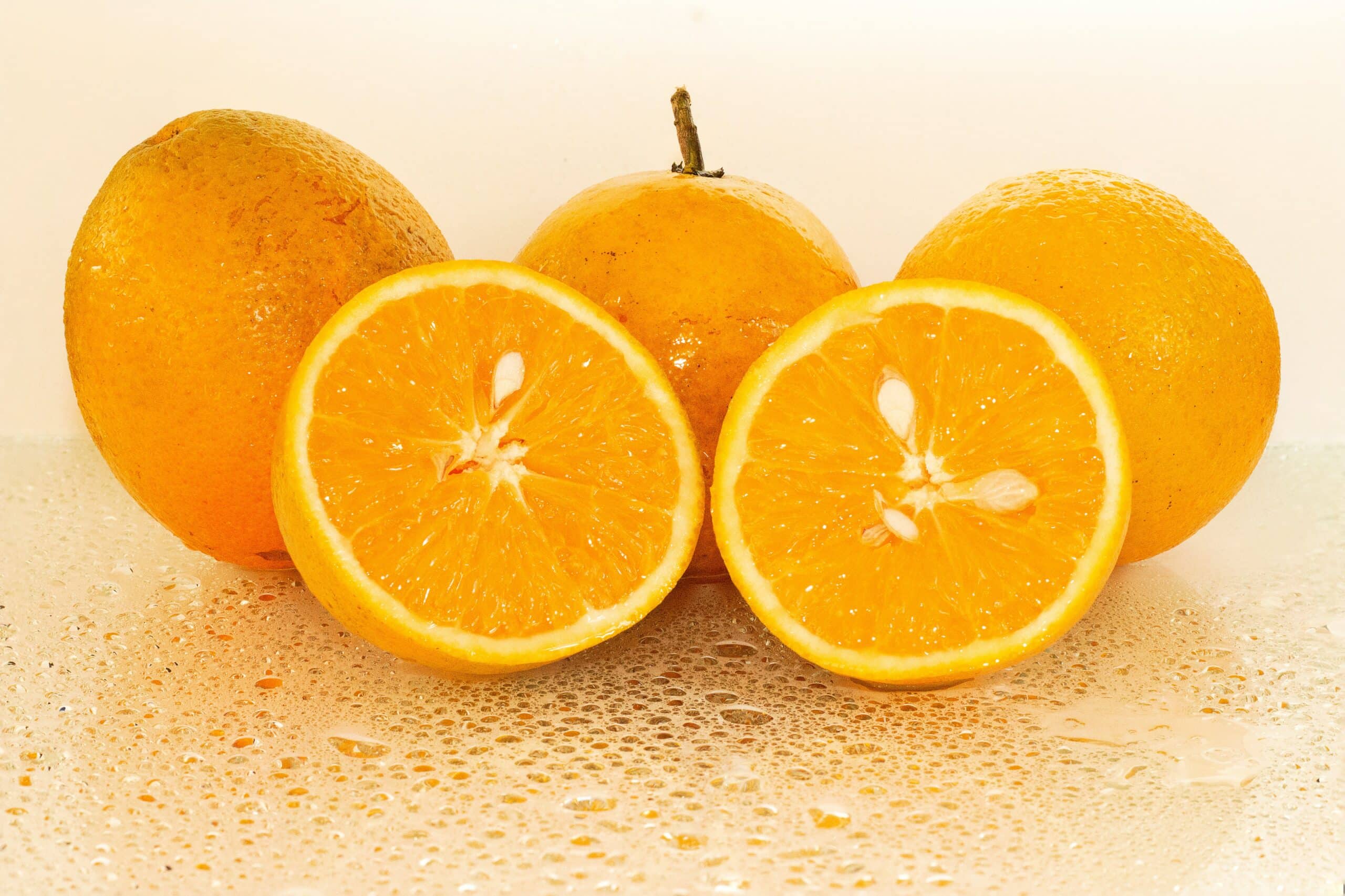 A few oranges and one is cut open