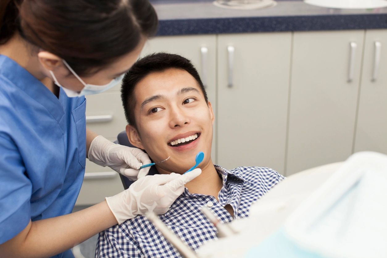 Man being treated by a dentist