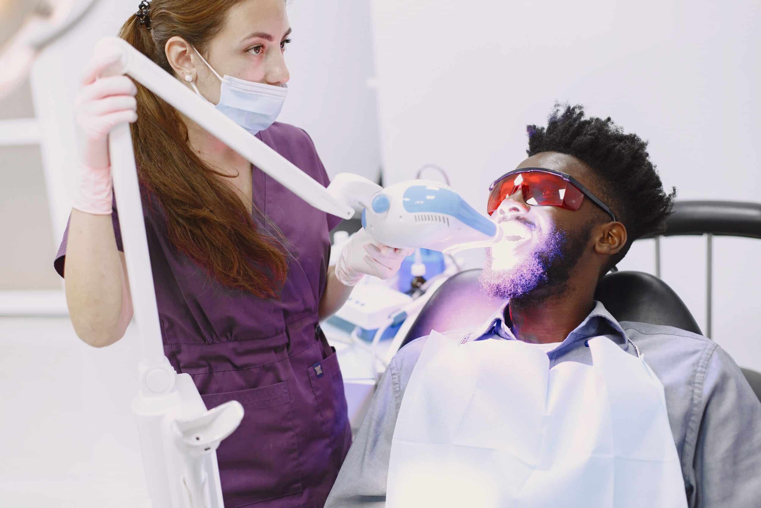 A man having his teeth whitened at the dentist